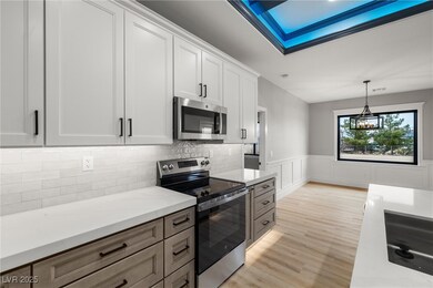 Kitchen with a wainscoted wall, appliances with st