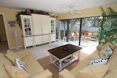 Living area with a ceiling fan and light tile patt