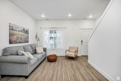 Living area featuring wood finished floors and recessed lighting