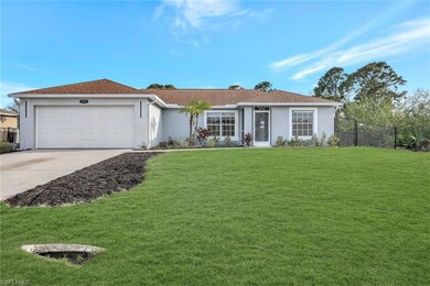 Ranch-style house with a front yard, concrete driv