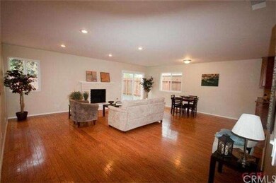Canned lighting, brick fireplace and wood flooring