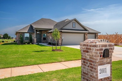 View of front of house featuring a garage, concrete driveway, brick siding, a shingled roof, and board and batten siding