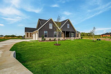 View of front of home with a front lawn and a garage