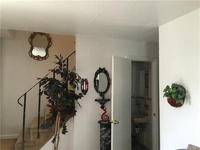 Above is another view of stairwell with half bath 