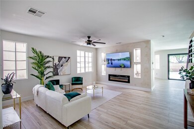 Living area with a glass covered fireplace, visibl