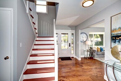 Large formal entry with rich hardwood flooring whi