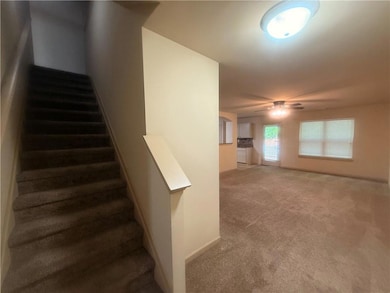 Stairway featuring baseboards, carpet flooring, an