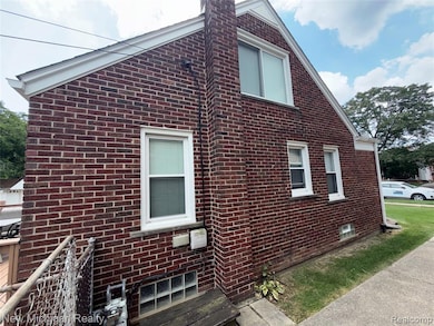 View of property exterior with brick siding and a chimney