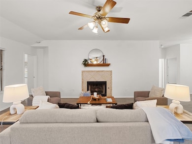 Living room featuring wood finished floors, a til