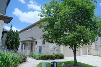 View of front of home featuring driveway, stone s