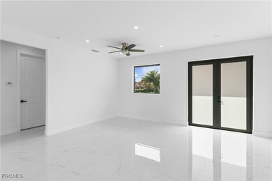 Empty room featuring recessed lighting, light marble finish floors, and a ceiling fan