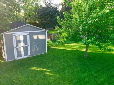 Large storage shed with newer siding and roof in t