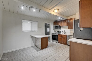 Kitchen with rail lighting, stainless steel applia