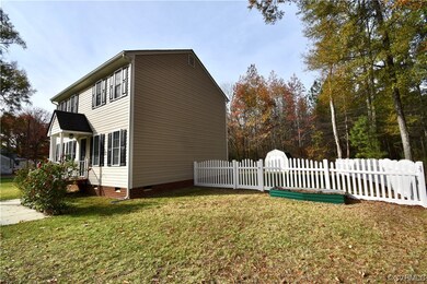 View of side of home with a lawn