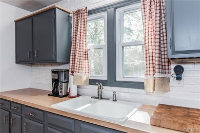 Kitchen sink overlooks rear fenced yard.
