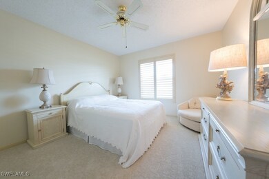 Bedroom featuring light carpet, a ceiling fan, and
