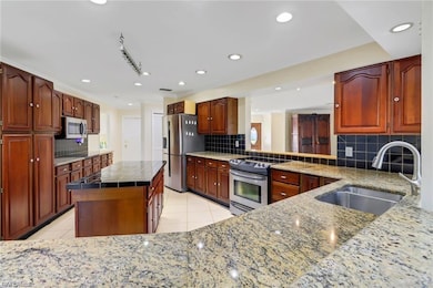 Kitchen with a center island, appliances with stai