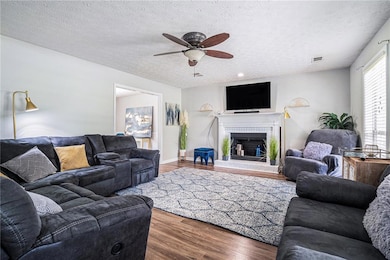 Living room featuring a textured ceiling, a ceilin