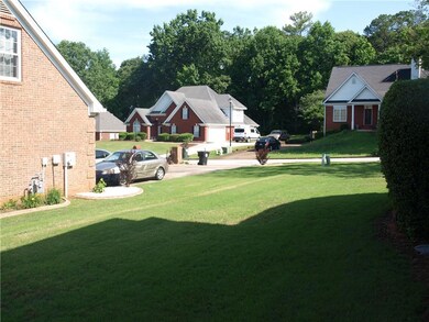 View of green lawn featuring driveway