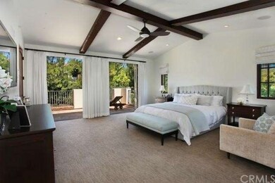 Elegant master bedroom retreat with beamed ceiling