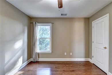 Spare room with a ceiling fan, baseboards, visible