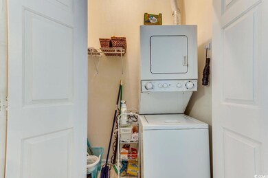 Washroom with stacked washer / dryer and laundry a