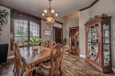 Dining room with ornamental molding, a chandelier,