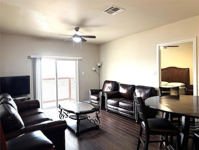 Living area with ceiling fan, dark wood finished f