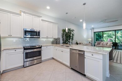 Kitchen featuring backsplash, appliances with stai