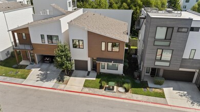 Contemporary home with a residential view, a garage, concrete driveway, a shingled roof, and a metal roof