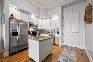 Kitchen with ornamental molding, light wood-style