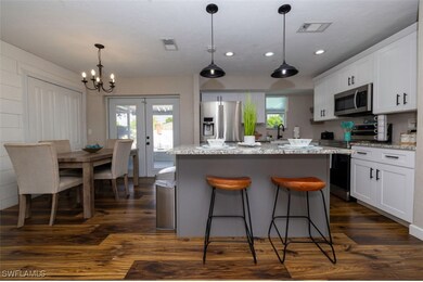 Kitchen with dark wood-type flooring, white cabine