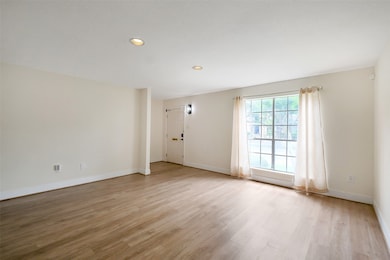 In the living room area looking towards the front door.