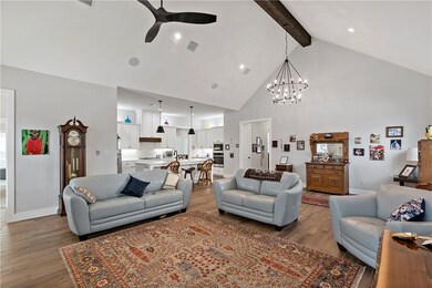 Living room featuring ceiling fan with notable cha