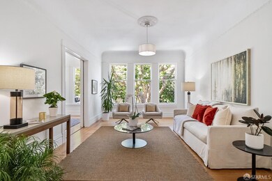 The formal living room with pocket doors, tall bay