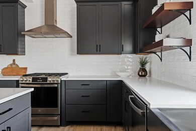 Kitchen with island, pendant lighting and open shelving