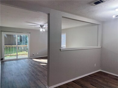 Spare room featuring wood finished floors, a textu