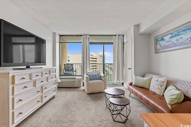 Living room with light carpet and a textured ceili