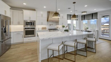 Kitchen with a kitchen bar, light stone counters,
