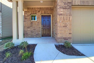 Entrance to property featuring brick siding