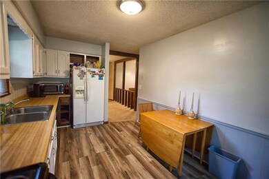Kitchen with New flooring, fresh New paint on Cabi