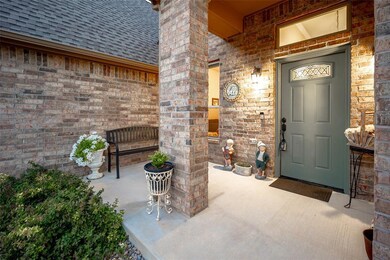 Doorway to property featuring brick siding and roo