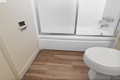 Bathroom with wood finished floors and  shower combination