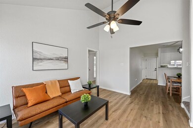 Living room with a high ceiling, wood-type floorin