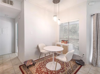 Dining room with light tile patterned floors, bas