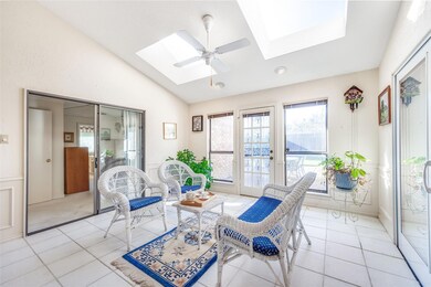 Sitting room featuring ceiling fan, vaulted ceilin