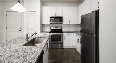 Kitchen with tasteful backsplash, stainless steel 