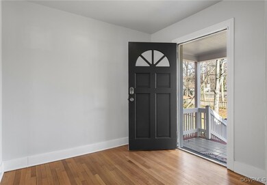 Entrance foyer featuring hardwood / wood-style flo