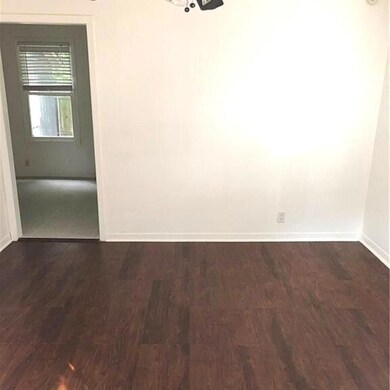 Unfurnished room featuring dark wood finished flo