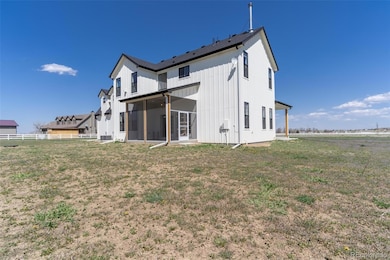 Back of home with full screened in patio.